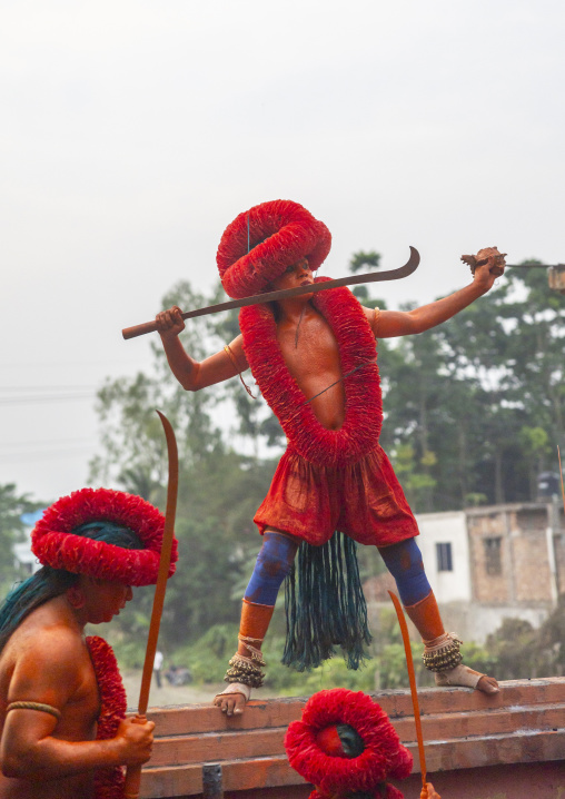 Hindu devotees covered with orange color dancing with swords at Lal Kach festival, Dhaka Division, Munshiganj Sadar, Bangladesh