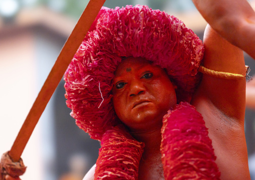 Hindu devotee with a sword covered with orange color at Lal Kach festival, Dhaka Division, Munshiganj Sadar, Bangladesh