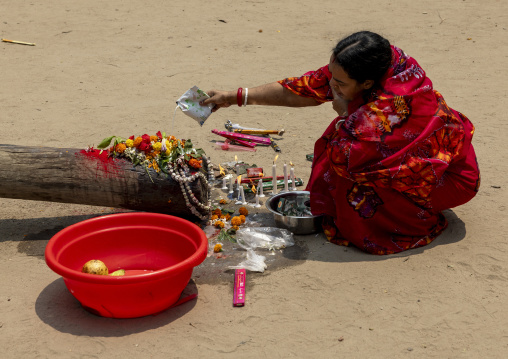 Bangladeshi hindu woman making offerings for a ceremony, Dhaka Division, Dhaka, Bangladesh