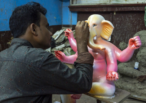 Bangladeshi artist painting a statue of Ganesha, Dhaka Division, Dhaka, Bangladesh