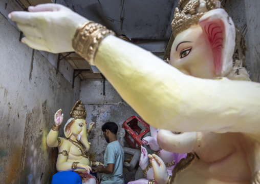 Bangladeshi artist painting a statue of Ganesha, Dhaka Division, Dhaka, Bangladesh