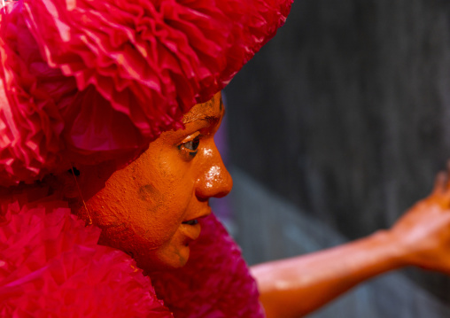 Portrait of a Hindu devotee covered with orange color at Lal Kach festival, Dhaka Division, Munshiganj, Bangladesh