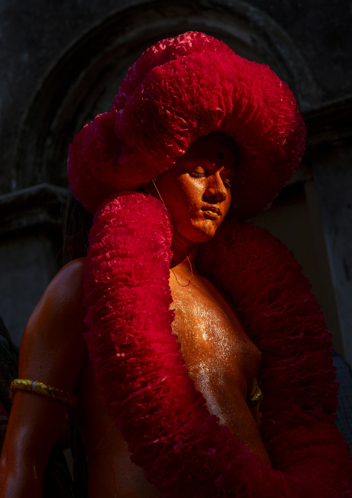 Portrait of a Hindu devotee covered with orange color at Lal Kach festival, Dhaka Division, Munshiganj, Bangladesh
