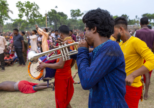 Man playing trumpet during Charak Puja hindu festival, Sylhet Division, Kamalganj, Bangladesh