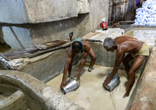 Bangladeshi men washing salt in water in a factory, Chittagong Division, Chittagong, Bangladesh