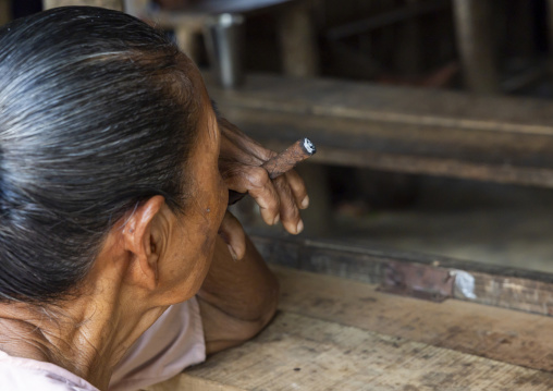 Marma old woman smoking a cigar, Chittagong Division, Rowangchhari, Bangladesh