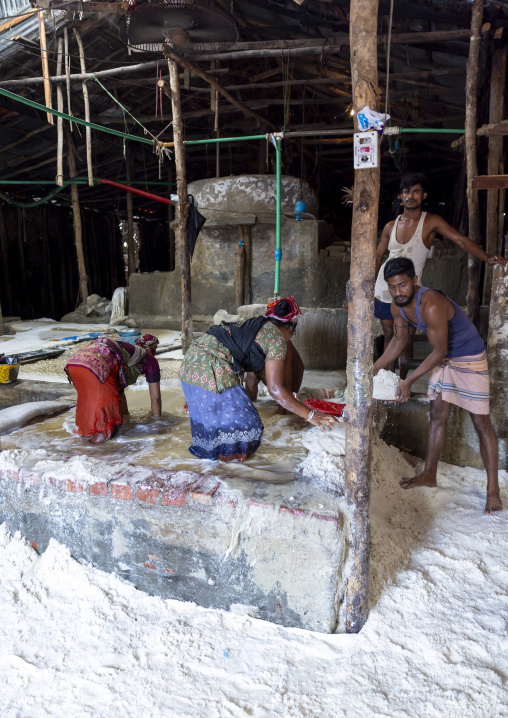 Bangladeshi workers washing salt in water in a factory, Chittagong Division, Chittagong, Bangladesh