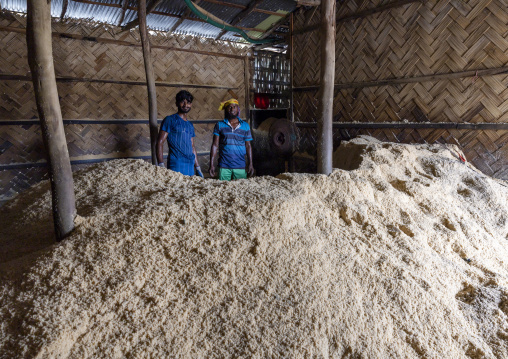 Bangladeshi workers packing salt in bags in a factory, Chittagong Division, Chittagong, Bangladesh