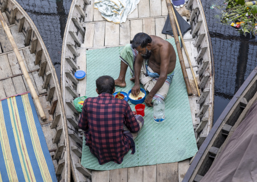 Bangladeshi men having lunch on their small boat, Dhaka Division, Dhaka, Bangladesh