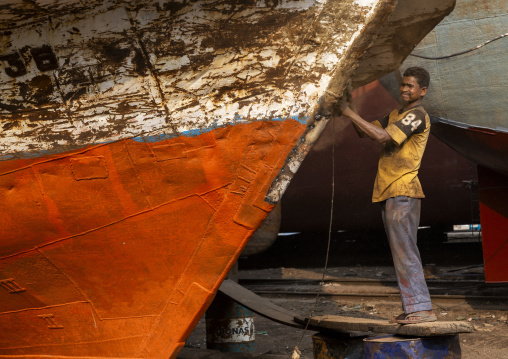 Worker at Dhaka Shipyard removing rust, Dhaka Division, Keraniganj, Bangladesh