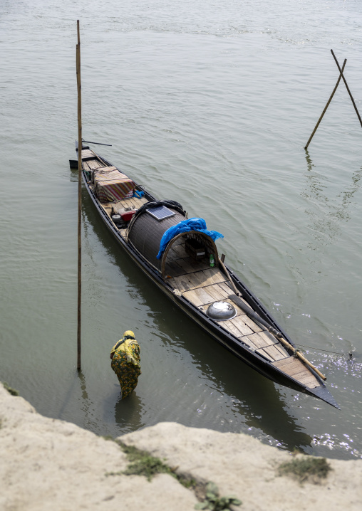 Bangladeshi woman embarking on a fishing boat, Dhaka Division, Shivalaya, Bangladesh