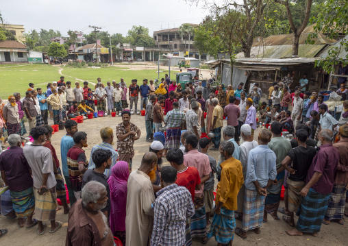 Bangladeshi farmers selling their fresh cow milk in the market, Dhaka Division, Dhamrai, Bangladesh