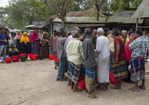 Bangladeshi farmers selling their fresh cow milk in the market, Dhaka Division, Dhamrai, Bangladesh