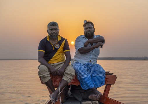 Bangladeshi fishermen on their boat at sunset, Rajshahi Division, Rajshahi, Bangladesh