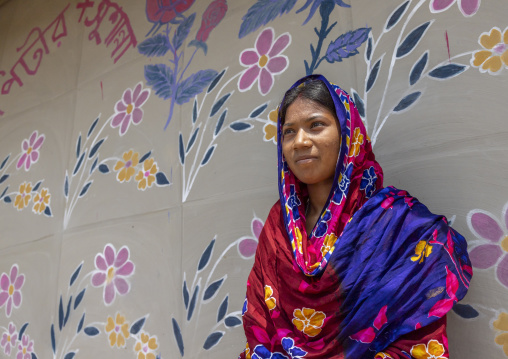 Christian woman from Santal ethnic group in front of a wall painting, Rajshahi Division, Tanore, Bangladesh
