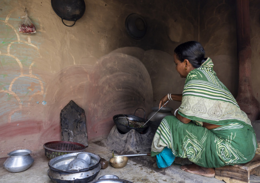 Bangladeshi woman cooking in her kitchen, Rajshahi Division, Tikoil, Bangladesh