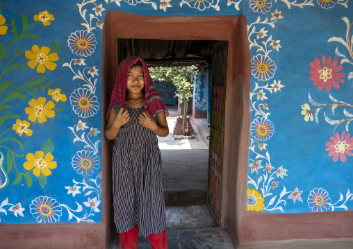 Bangladeshi girl in front of a traditional wall painting in a house, Rajshahi Division, Tikoil, Bangladesh
