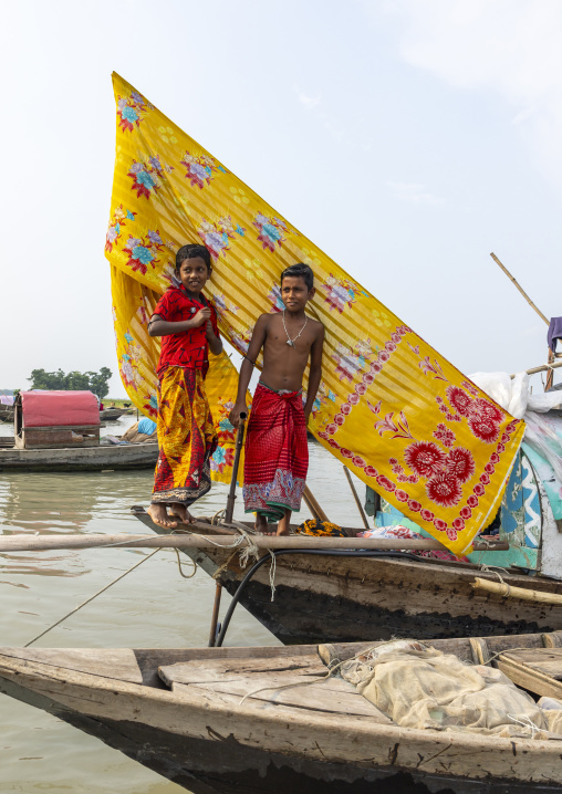 River gypsy boys living on a boat , Barisal Division, Barisal, Bangladesh