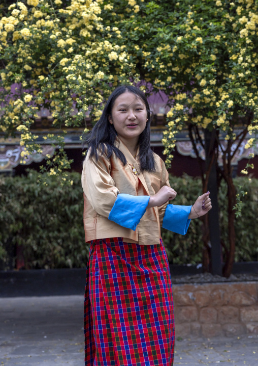 Bhutanese teenage girl dancing in the street, Chang Gewog, Thimphu, Bhutan