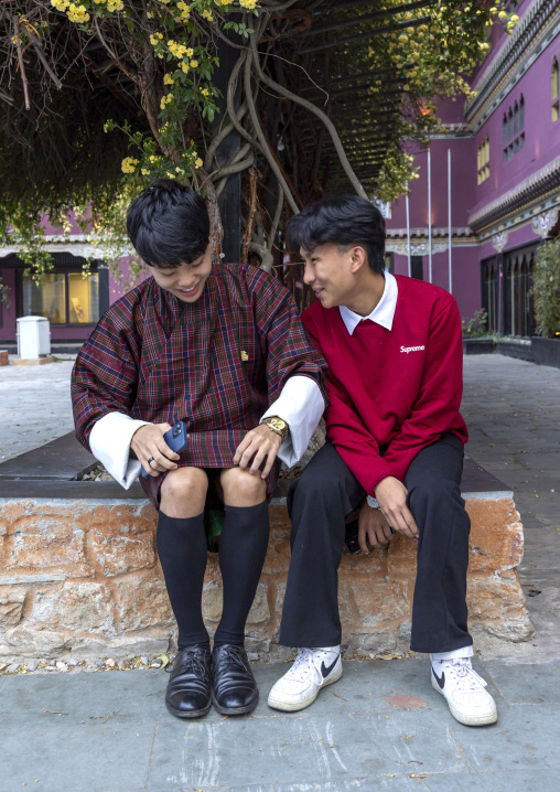 Bhutanse teenage boys dressed in modern and traditional clothing, Chang Gewog, Thimphu, Bhutan