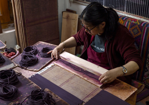 Bhutanese woman manufacturing Incense sticks in Nado Poizokhang , Chang Gewog, Thimphu, Bhutan