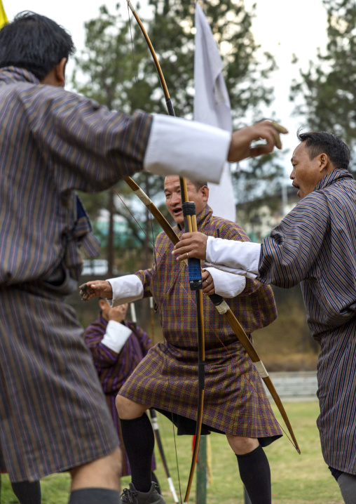 Bhutanese archers celebrating victory on an archery range, Chang Gewog, Thimphu, Bhutan