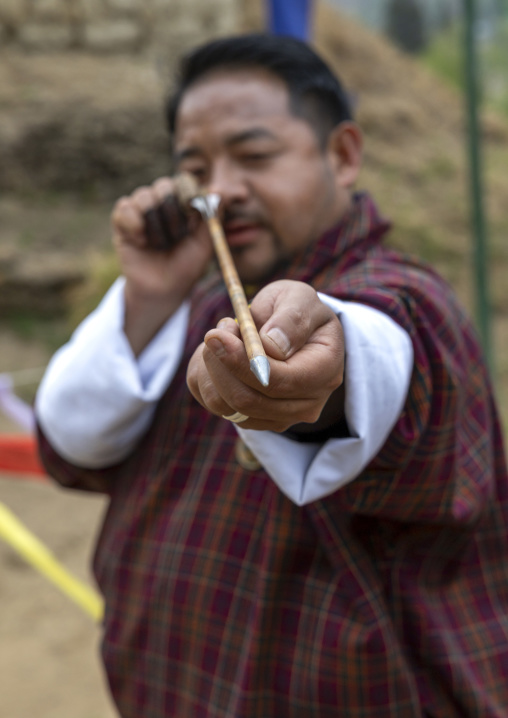 Bhutanese archer looking at an arrow during a competition, Chang Gewog, Thimphu, Bhutan