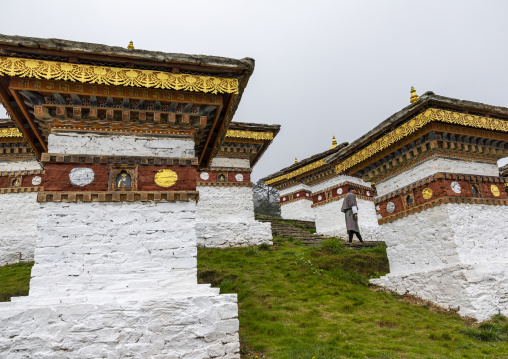 Butanese pilgrim in Dochu La with 108 stupas or chortens, Punakha, Dochula Pass, Bhutan