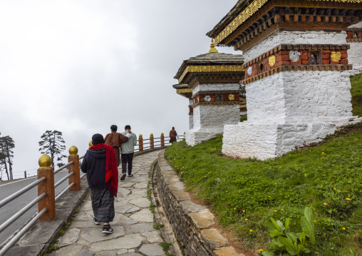 Butanese pilgrims in Dochu La with 108 stupas or chortens, Punakha, Dochula Pass, Bhutan