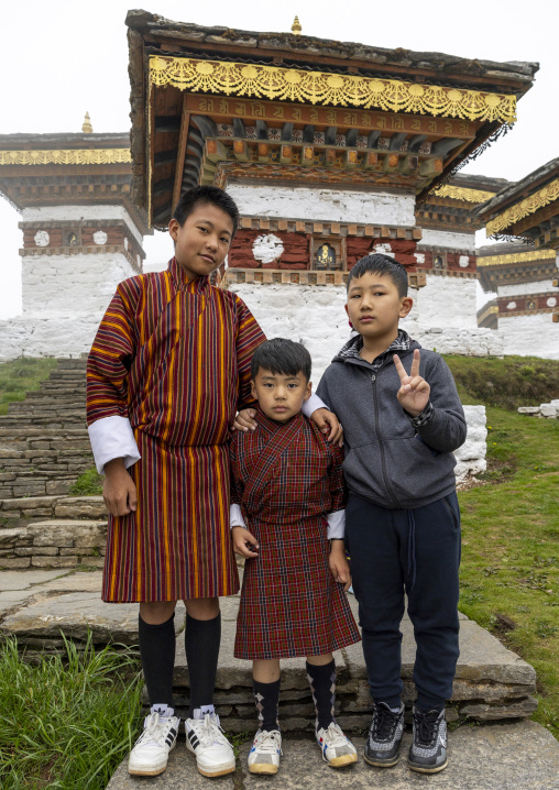 Butanese children in Dochu La with 108 stupas or chortens, Punakha, Dochula Pass, Bhutan