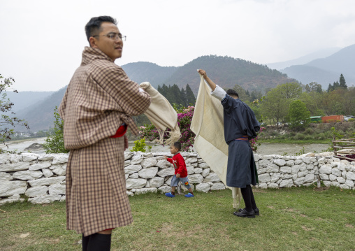 Bhutanese men putting kabney scarves in Punakha Dzong, Punakha dzongkhag, Punakha, Bhutan