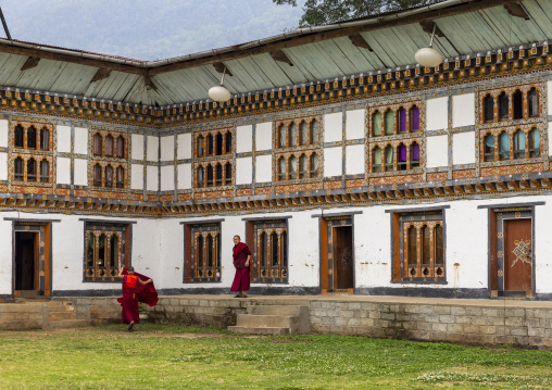 Bhutanese monks in Nyenzer Lhakhang courtyard, Thedtsho Gewog, Wangdue Phodrang, Bhutan
