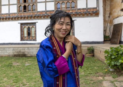 Woman washing her hair with sacred water in Nyenzer Lhakhang, Thedtsho Gewog, Wangdue Phodrang, Bhutan