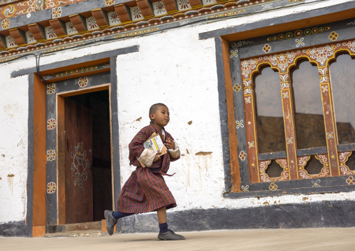 Bhutanese novice monk back from school in Nyenzer Lhakhang, Thedtsho Gewog, Wangdue Phodrang, Bhutan