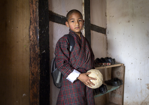 Bhutanese novice monk back from school in Nyenzer Lhakhang, Thedtsho Gewog, Wangdue Phodrang, Bhutan