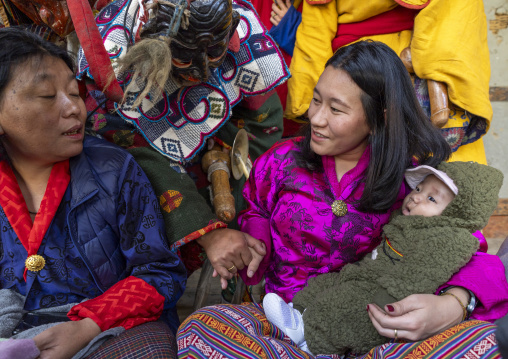 Astara with a mother and her baby in Ura Yakchoe festival, Bumthang, Ura, Bhutan