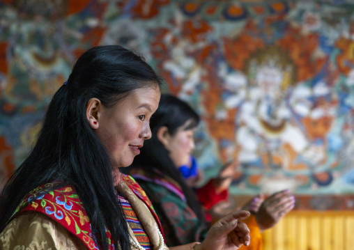 Bhutanese women dancing during Ura Yakchoe in the temple, Bumthang, Ura, Bhutan