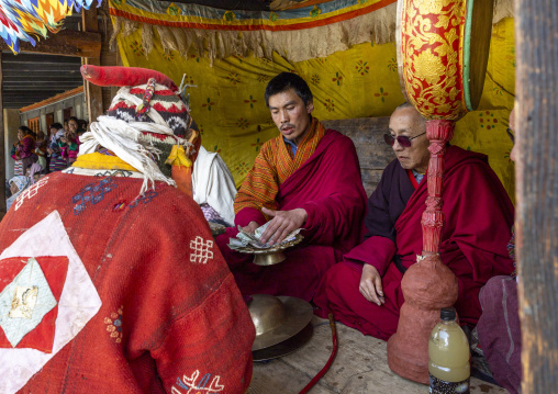 Bhutanese leaders receiving money donations in Ura Yakchoe festival, Bumthang, Ura, Bhutan