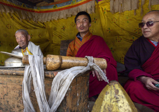 Monks with wooden phallus in Ura Lhakhang during festival, Bumthang, Ura, Bhutan
