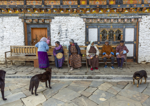 Old bhutanese people resting on bench in Jamphel Lhakhang, Chhoekhor Gewog, Bumthang, Bhutan