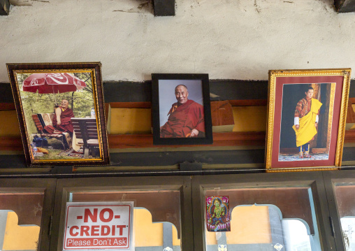 Dalai Lama and Bhutan King pictures in a shop, Chhoekhor Gewog, Bumthang, Bhutan