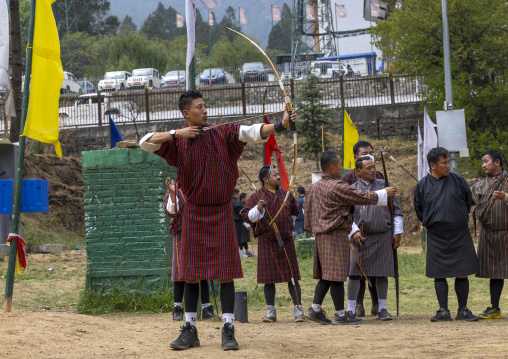 Bhutanese man aims arrow in archery competition, Chang Gewog, Thimphu, Bhutan