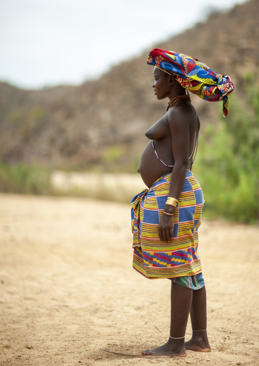 Pregnant Mucubal tribe woman wearing oyonduthi bra, Namibe Province, Virei, Angola