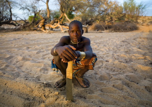 Mucubal tribe teenager with an omotungo knife, Namibe Province, Virei, Angola