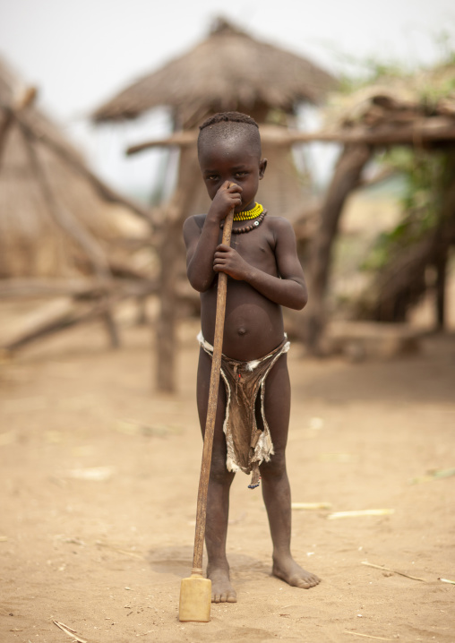 Karo tribe boy standing in the middle of a village, Omo valley, Korcho, Ethiopia