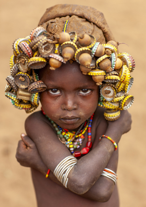 Dassanech boy wearing bottle caps headwear, Omo valley, Omorate, Ethiopia