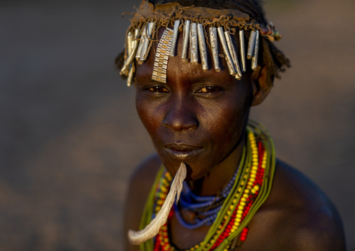 Dassanech tribe woman with a feather in the chin, Omorate, Omo valley, Ethiopia