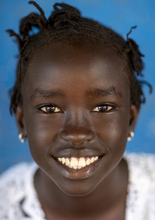 Anuak tribe smiling girl portrait, Gambella region, Gambella, Ethiopia