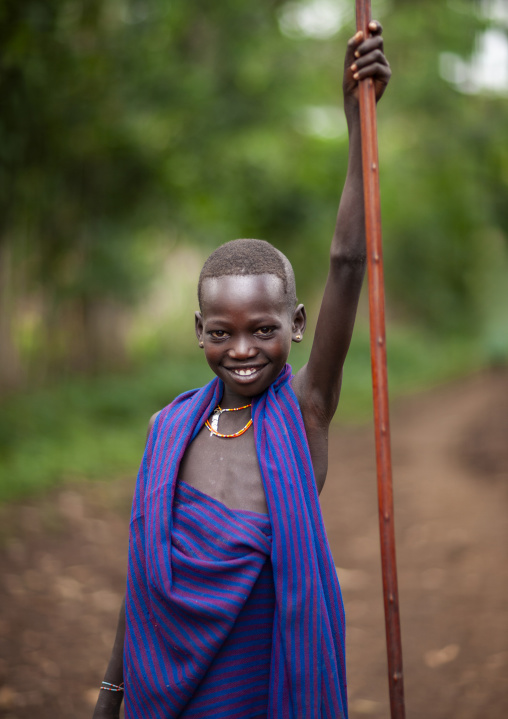 Menit boy holding a stick, Omo valley, Tum, Ethiopia