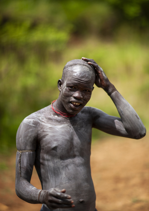 Clay body paintings on suri warriors before donga stick fighting, Tulgit, Omo valley, Ethiopia